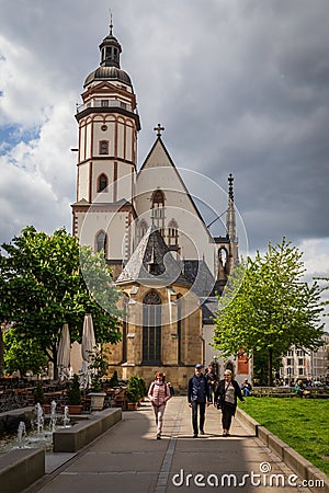 Leipzig Germany - May 3 2019: Tourists walk near the famous Thomaskirche where composer Johann Sebastian Bach was a Editorial Stock Photo