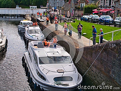 Leisure cruiser boats pass through the staircase locks at Fort Augustus in the Great Glen, Scotland, UK Editorial Stock Photo