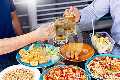 Leisure, holidays with beer grilled meat and vegetables served, Young People chatting and having drinks together enjoying outdoor Stock Photo