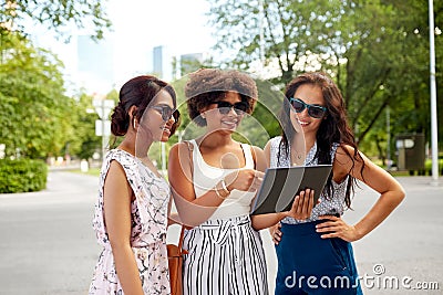 Women with tablet pc on street in summer Stock Photo