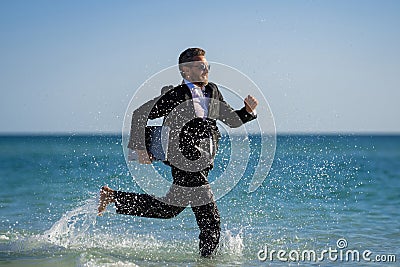 Leisure weekend and remote freelance work. Crazy comic business man in suit run on sea. Funny businessman with laptop Stock Photo