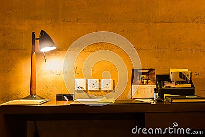 Leisure working desk under a glowing lamp Stock Photo