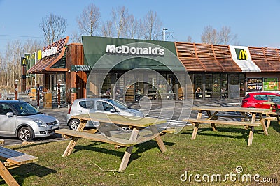 Car park near Dutch motorway with Mc Donald`s fastfood restaurant Editorial Stock Photo