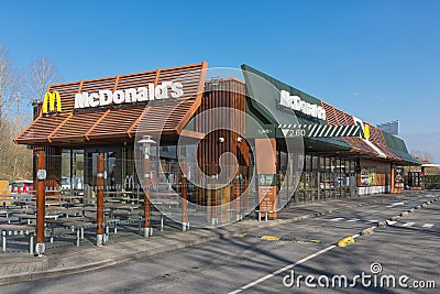 Exterior of modern Mc Donald`s fastfood restaurant with drive-thru Editorial Stock Photo