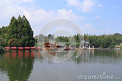 Landscape view with big pond, trees, blue sky at Floating Market, Lembang, Bandung, Indonesia Editorial Stock Photo