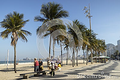 Leme beach boulevard with Portuguese tile pavement and palm trees Editorial Stock Photo