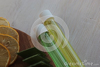 Lemon, aloe vera, and glass vials of colored liquid. Stock Photo