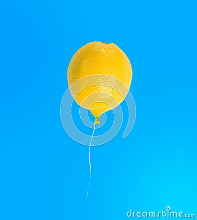 Lemon balloon isolated on blue background Stock Photo