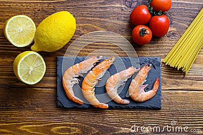 Lemon Garlic Shrimp with Spaghetti Ingredients classic recipe on wood table, top view Stock Photo