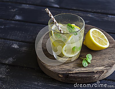 Lemon, ginger and mint lemonade on a wooden rustic board. Stock Photo