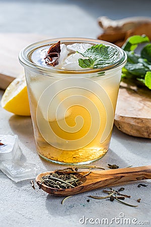 Lemon green tea in glass with anise ice. Heathy probiotic drink Stock Photo