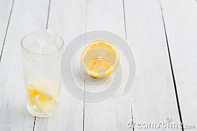 Lemon juice detox water. Mineral water infused with lemons. Wooden white table. Stock Photo