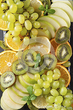 Lemon, kiwi, Apple slices, orange , green grapes, mint sprig fresh citrus Stock Photo