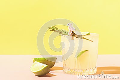 Lemon lemonade drink in elegant glasses on a bright pastel colored background. Bright sunshine. Summer concept. Stock Photo
