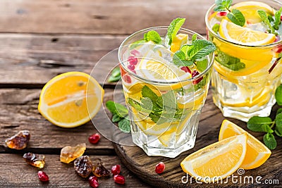 Lemon mojito cocktail with mint and pomegranate Stock Photo