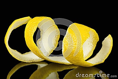 Lemon peel or lemon twist on black background. Lemon slice as cocktail ingredient Stock Photo