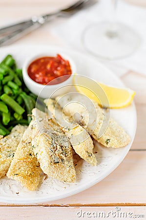 Lemon Semolina Crusted Fish Fries with Green Beans and Marinara Stock Photo