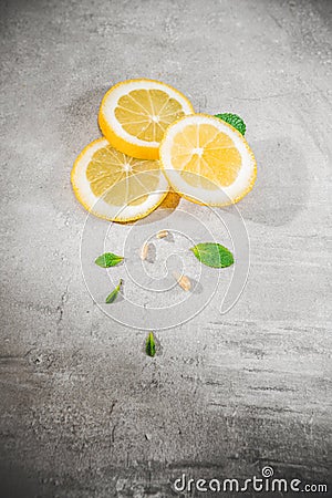 Lemon slice on gray table. Fresh citrous fruits piece, with copyspace Stock Photo