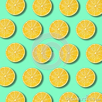 Lemon slices pattern on vibrant green color background Stock Photo