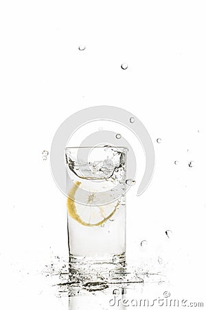 Lemon splashes in water glass isolated on white background Stock Photo