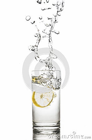 Lemon splashes in water drop glass isolated on white background Stock Photo