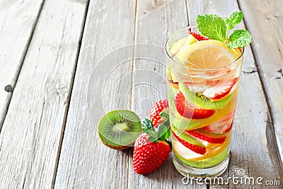 Lemon, strawberry, kiwi detox water against rustic wood Stock Photo