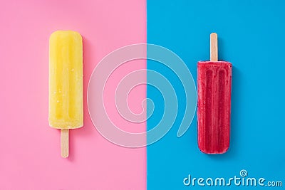 Lemon and strawberry popsicle on pink and blue background Stock Photo