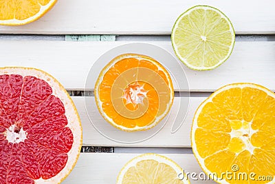 Lemon, tangerine, orange and pink grapefruit on white wood Stock Photo