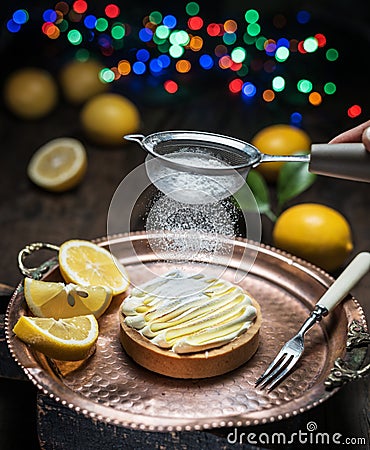 Lemon tart. Cooking of lemon dessert. Blurred festive background Stock Photo