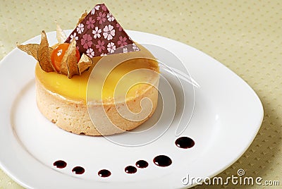 Lemon tart decorated and drops of orange sauce Stock Photo