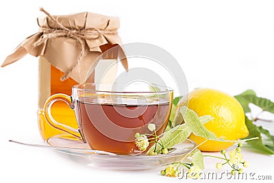 Lemon tea with linden honey jar and flowers Stock Photo
