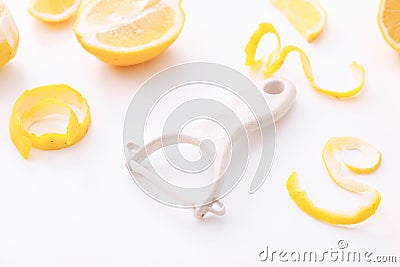 Lemon zest with zester on a white background. Close up Stock Photo