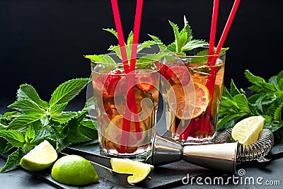 Cool strawberry mojito cocktail in glasses on dark table Stock Photo