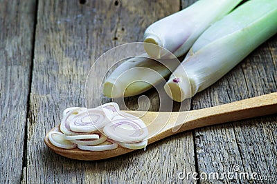 Lemongrass slice in wooden spoon on wooden table Stock Photo