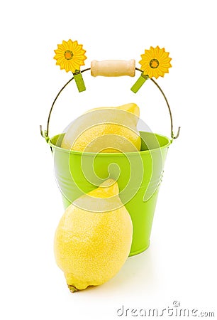 Lemons in green bucket on white Stock Photo