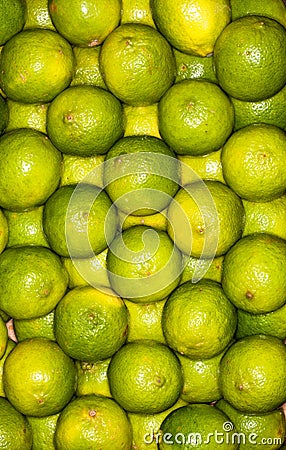 Lemons regular ordered pile background. Macro Stock Photo