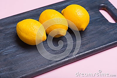 Lemons on a wooden board. citrus on a cutting board. Healthy food. Vitamins. Stock Photo