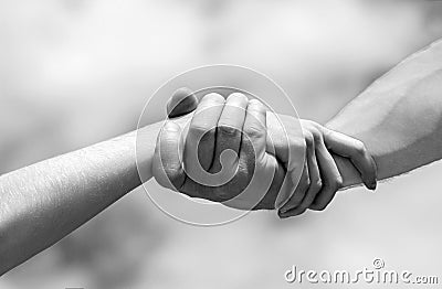 Lending a helping hand. Hands of man and woman reaching to each other, support. Solidarity, compassion, and charity Stock Photo