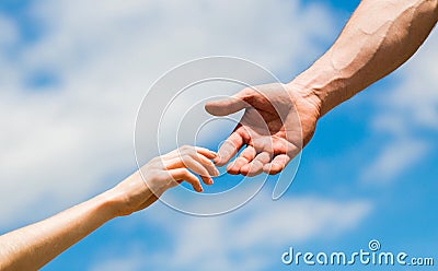 Lending a helping hand. Solidarity, compassion, and charity, rescue. Hands of man and woman reaching to each other Stock Photo