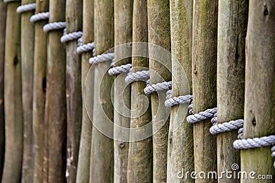 Length of wood fencing tied with rope Stock Photo