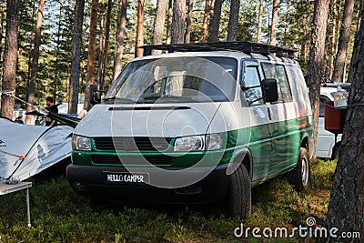 Leningrad Region, Russia - June 2022. Stylish green and white Volkswagen transporter T4 with expedition trunk - house on Editorial Stock Photo