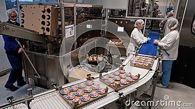 Leningrad Region, Russia - November 5, 2019: The final stage in the production of yoghurts, working inspectors check the quality Editorial Stock Photo