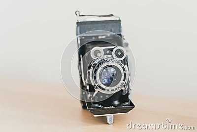lens accordion on an old camera. Old vintage camera on a wooden light background Stock Photo
