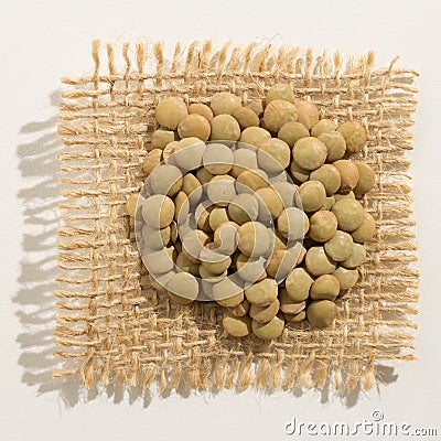 Lentil legume. Close up of grains over burlap. Stock Photo