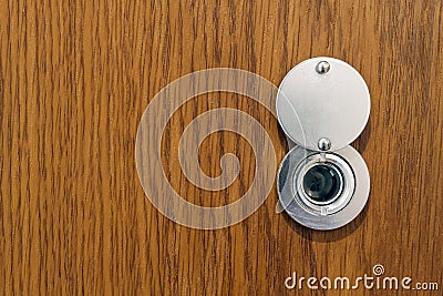 Lens peephole on new wooden texture front door Stock Photo