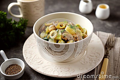 Lenten potato salad with fried mushrooms, green onions, green olives, dill with olive oil and white wine vinegar. Stock Photo