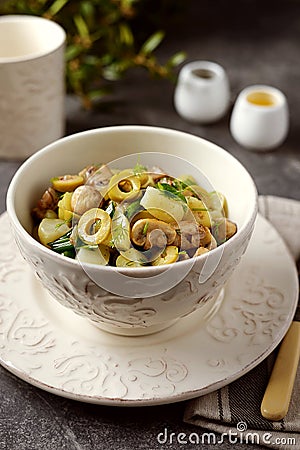 Lenten potato salad with fried mushrooms, green onions, green olives, dill with olive oil and white wine vinegar. Stock Photo