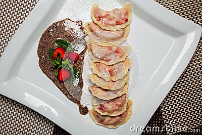 Lenten, vegetarian menu - vareniki with cherries and strawberry sauce Stock Photo