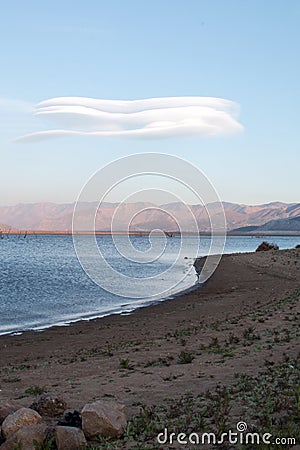 Lenticular cloud hovering above drought stricken Lake Isabella in the southern range of California's Sierra Nevada mountains Stock Photo