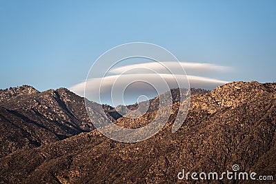 Lenticular clouds over mountain II Stock Photo